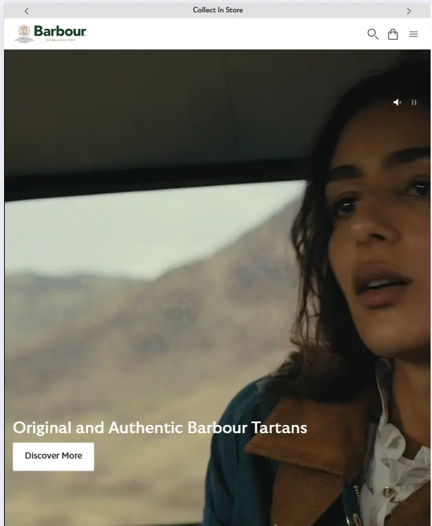 Barbour website homepage featuring a close-up of a woman in a vehicle with text reading "Original and Authentic Barbour Tartans" and a "Discover More" button.